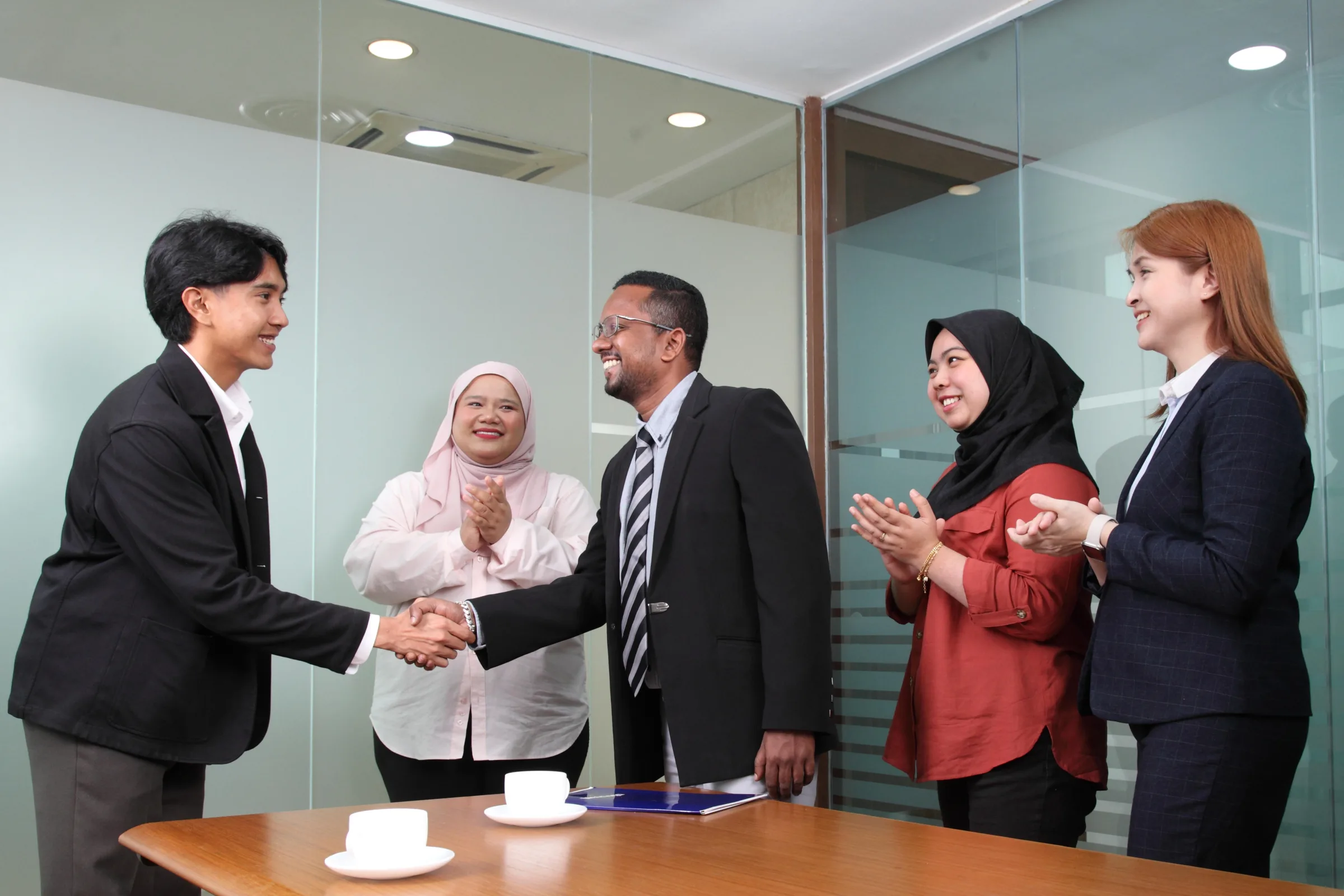 A Mesiniaga intern being welcomed by the team with a handshake